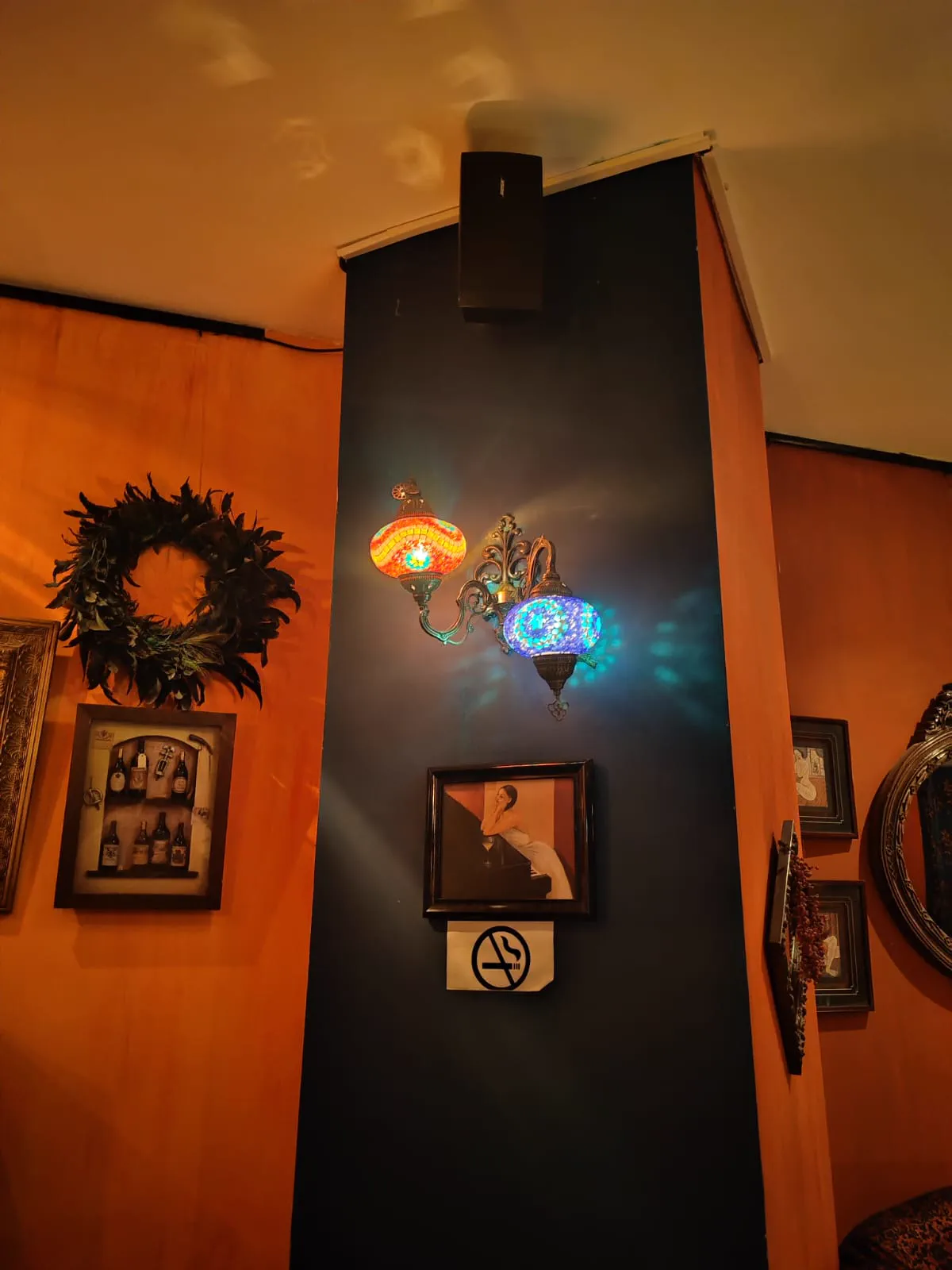 Coloured mosaic Turkish lamps glowing on a wall inside The Black Rose club in Addis Ababa