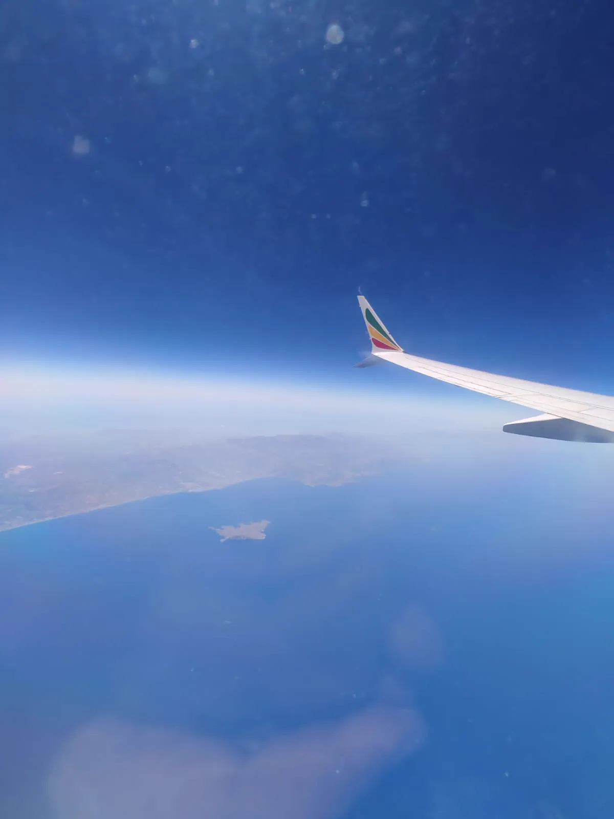 A Greek island and coastline seen from an Ethiopian Airlines window on the flight from Addis Ababa to Athens