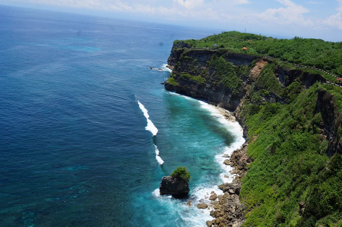 Green-topped limestone cliffs above deep blue sea on Bali's southern coast