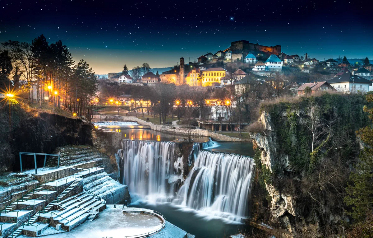 The waterfall below the old town of Jajce at dusk, Bosnia and Herzegovina