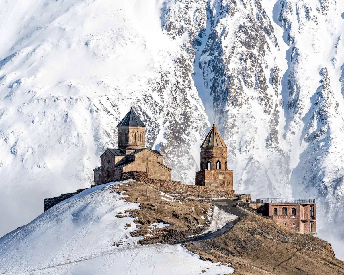 Gergeti Trinity Church on a snowy ridge below Mount Kazbek, Georgia
